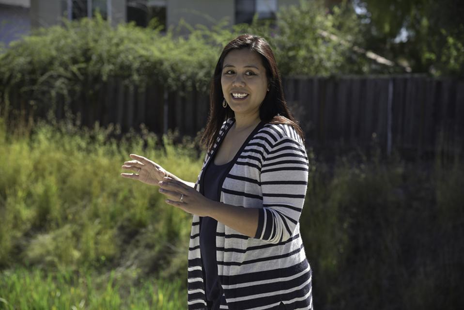 Zone 7 Water Agency employee, in a local Arroyo with hands facing outward
