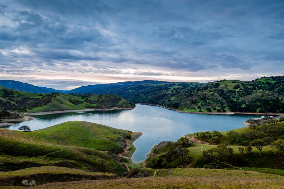 Aerial view of Lake Del Valle surrounded by mountains
