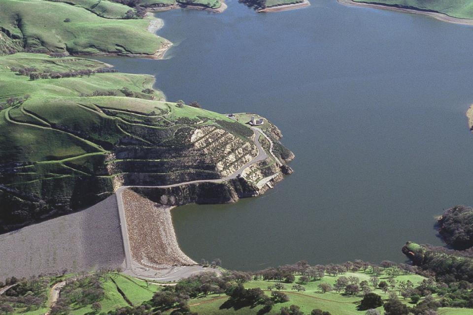 Dark blue lake in the middle of green hills and ridges