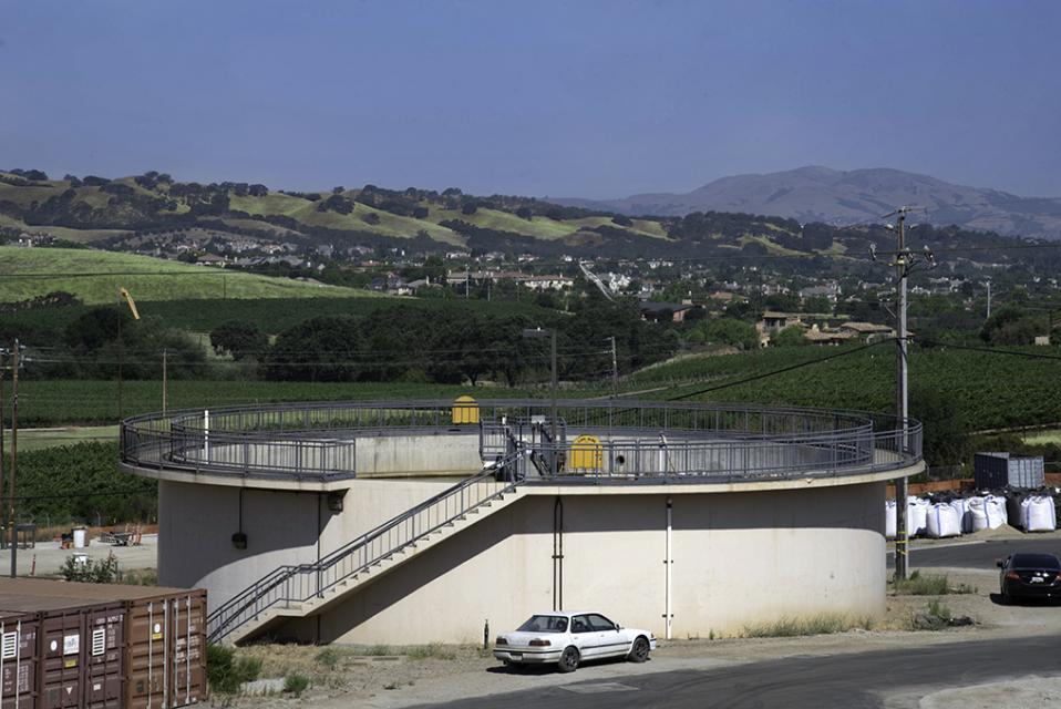 Water reservoir with green hills in the distance